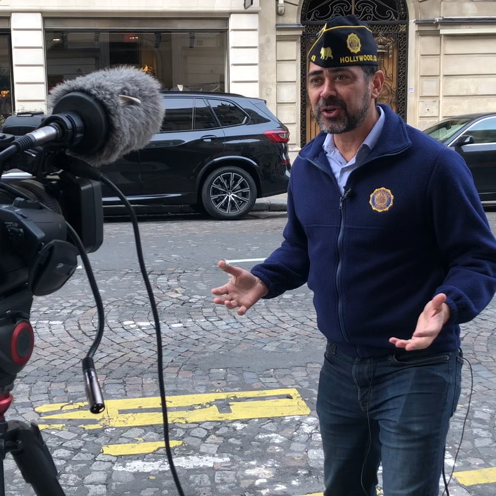 Video Journalist Jeric Wilhelmsen reporting on the streets of Paris in front of the original American Legion Paris Post 1 clubhouse.